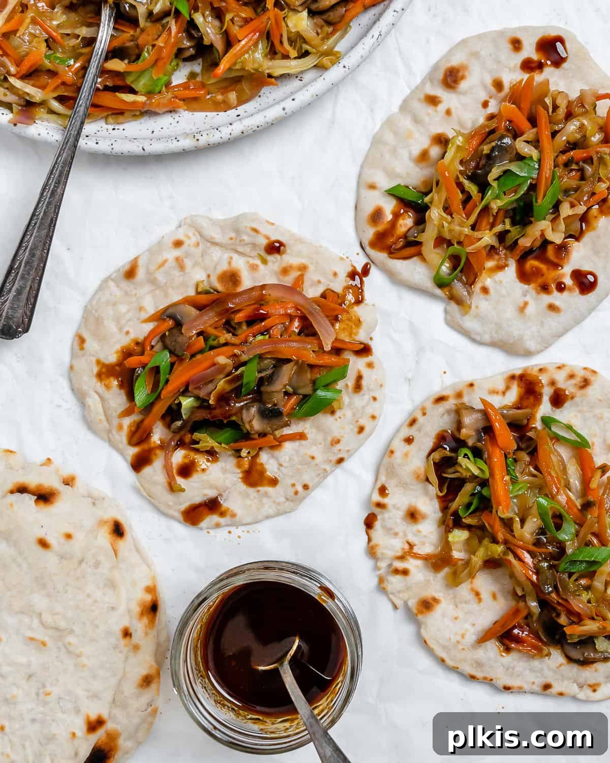 Vibrant Moo Shu Medley 15 Another beautiful shot of completed Moo Shu Vegetables on mandarin pancakes, presented on a white surface, highlighting the meal's fresh appeal.