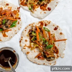 Vibrant Moo Shu Medley 16 completed Moo Shu Vegetables on mandarin pancakes against a white surface