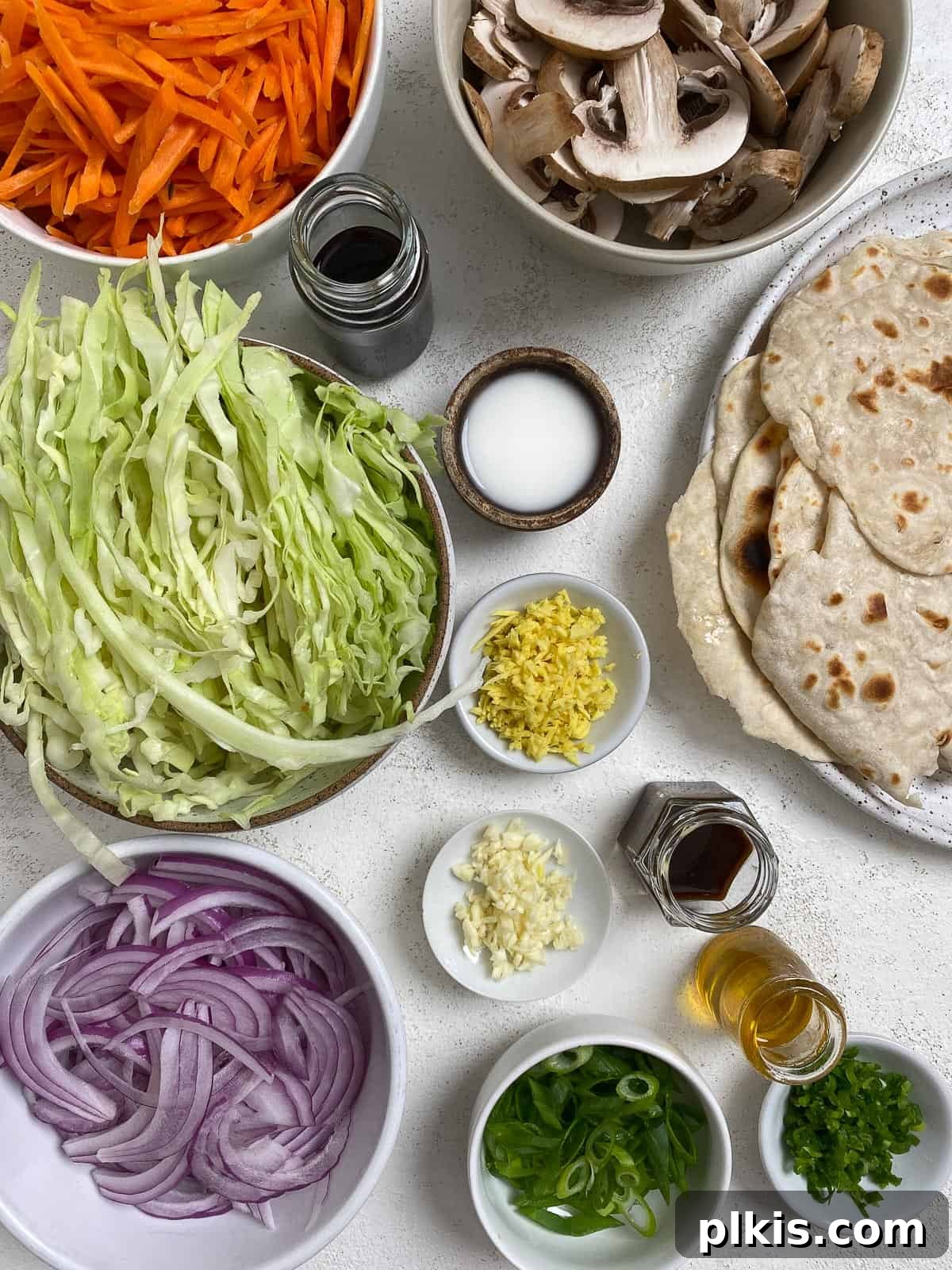 Vibrant Moo Shu Medley 3 Moo Shu Vegetable ingredients thoughtfully measured out and arranged against a clean white surface, showcasing fresh produce and pantry staples.