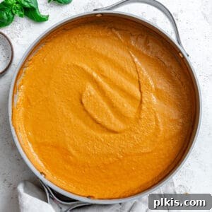 Completed Creamy Tomato Tofu Pasta Sauce on a white surface