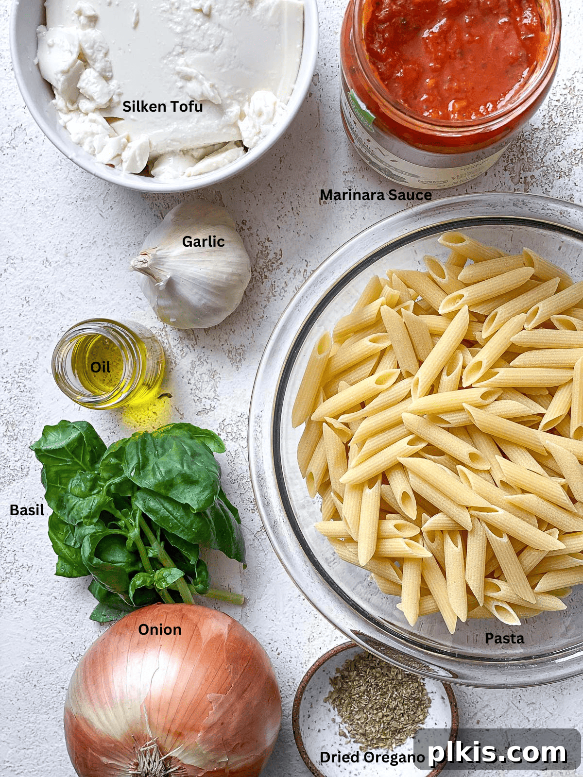 Velvety Tomato Tofu Pasta Delight 3 Ingredients for Creamy Tomato Tofu Pasta Sauce laid out on a white surface