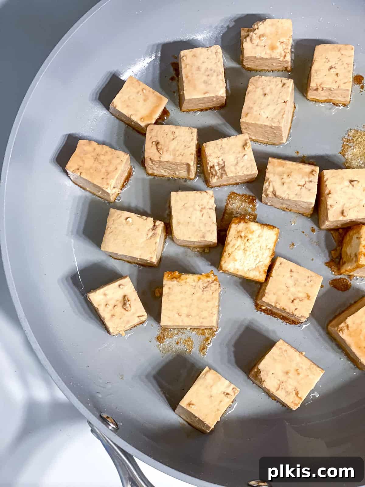 Golden Sesame Tofu 9 process shot of adding tofu to skillet to pan-fry