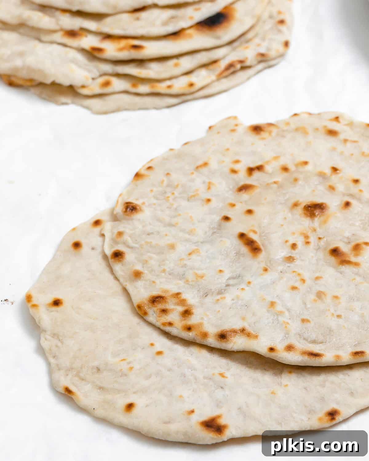 Delicate Chinese Wraps 2 Beautifully stacked Mandarin Pancakes against a clean white background, showcasing their perfect texture and golden hue.