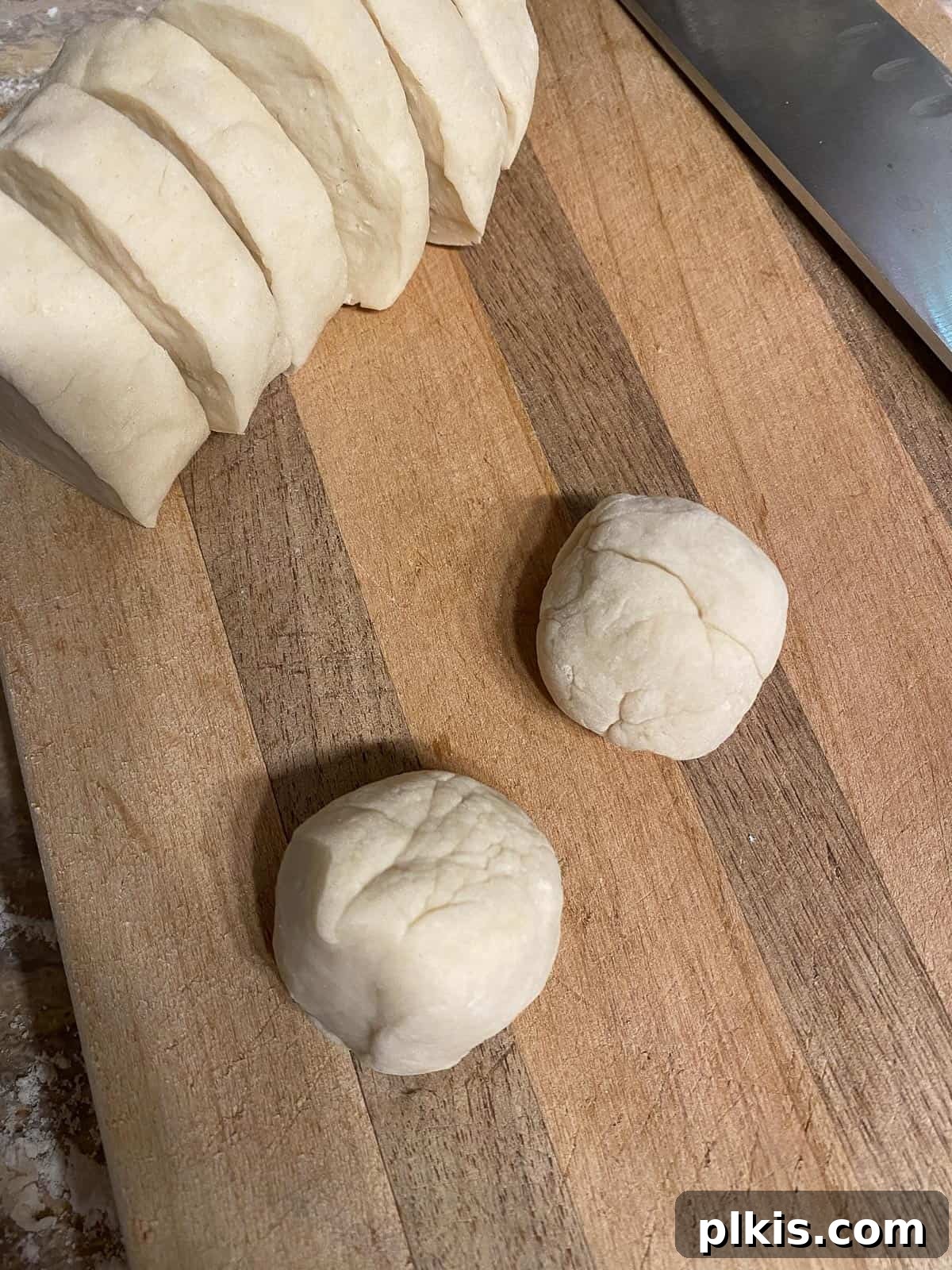 Delicate Chinese Wraps 10 Two pieces of dough shaped into small 1-inch circles on a cutting board.