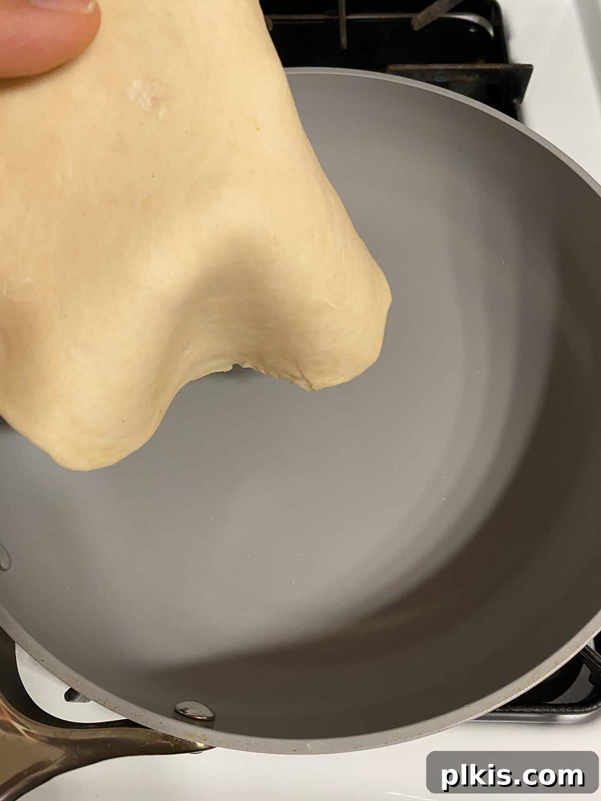 Delicate Chinese Wraps 15 A Mandarin Pancake cooking in a hot nonstick skillet, just placed in the pan.