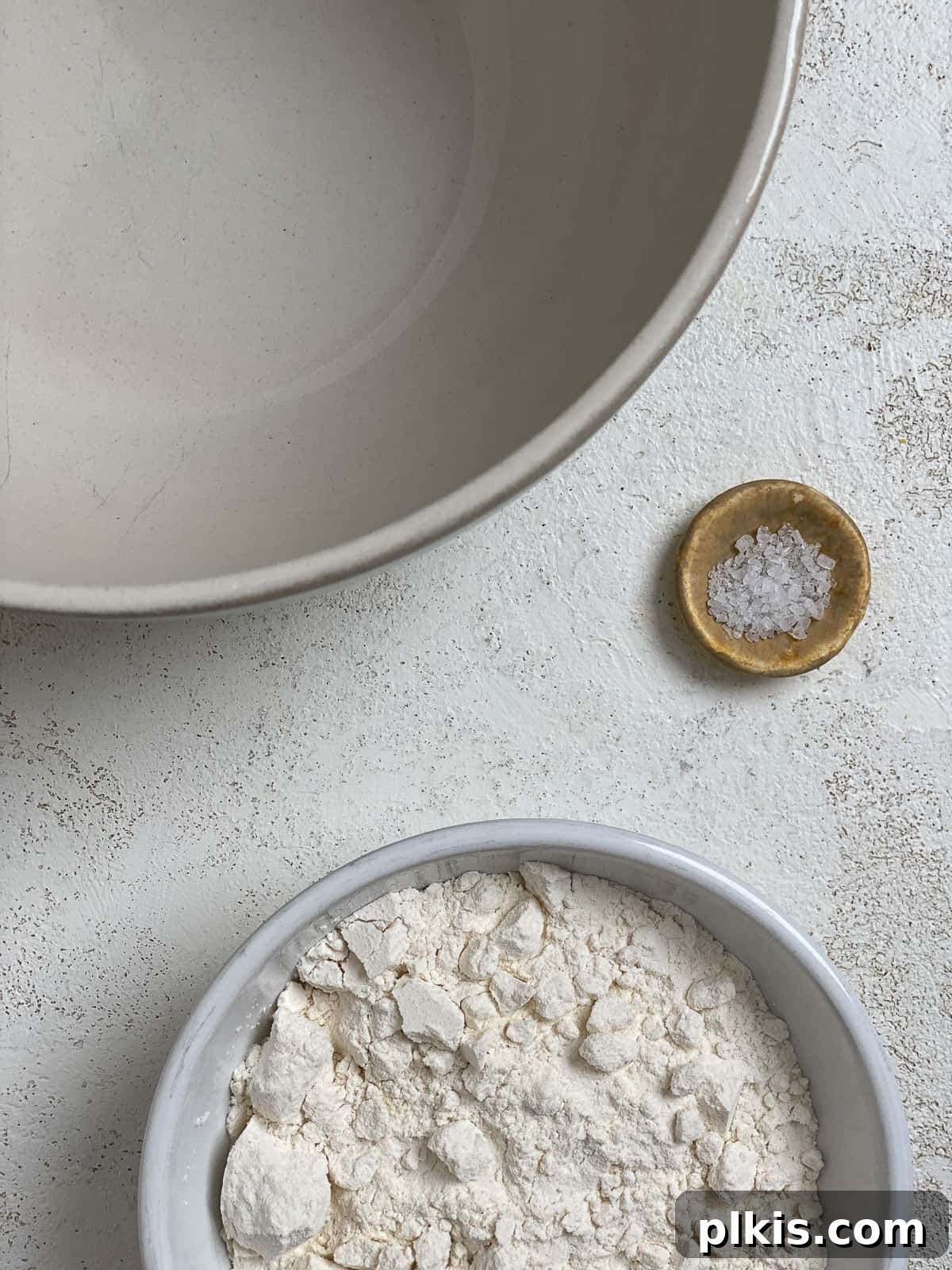 Delicate Chinese Wraps 4 A bowl containing all-purpose flour and salt, ready for mixing.