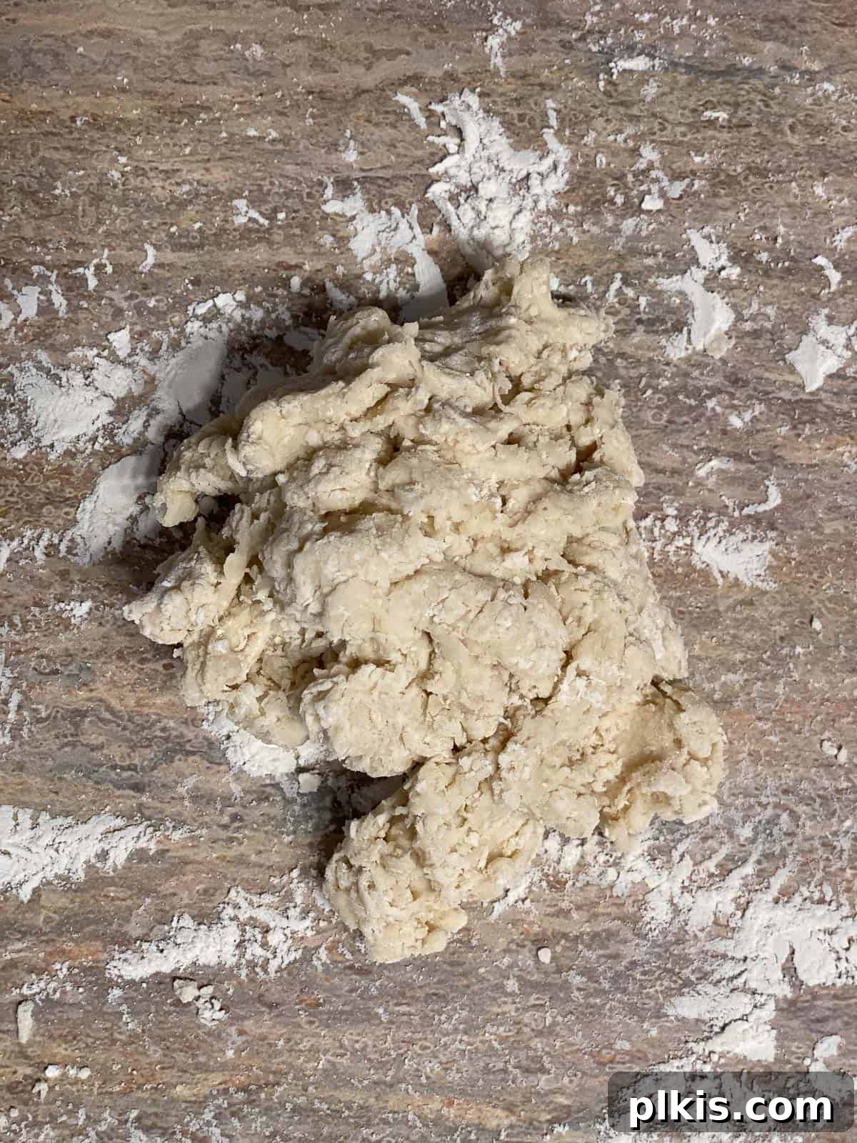Delicate Chinese Wraps 7 The dough being kneaded on a floured board, transforming from shaggy to smooth and elastic.