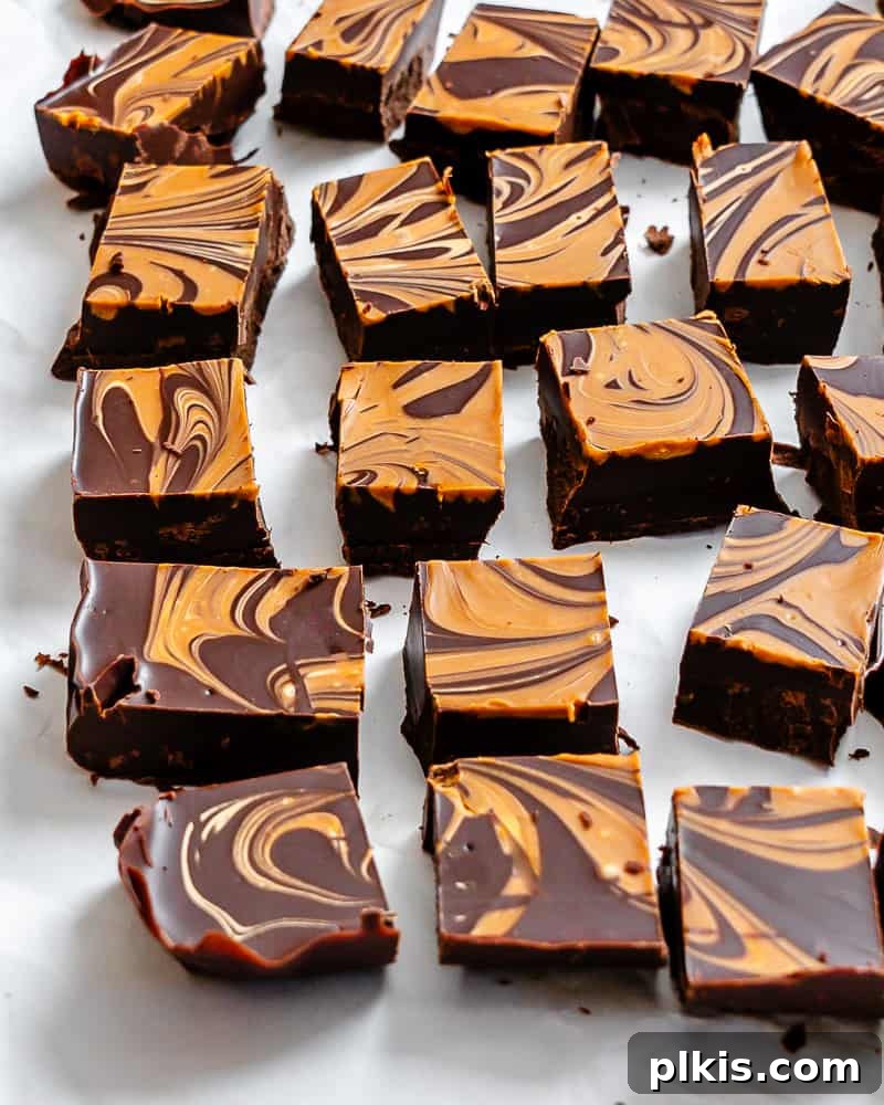 Two-Ingredient Biscoff Fudge Bliss 2 Delicious squares of easy 2-ingredient Biscoff fudge arranged on a white surface, ready to be enjoyed.