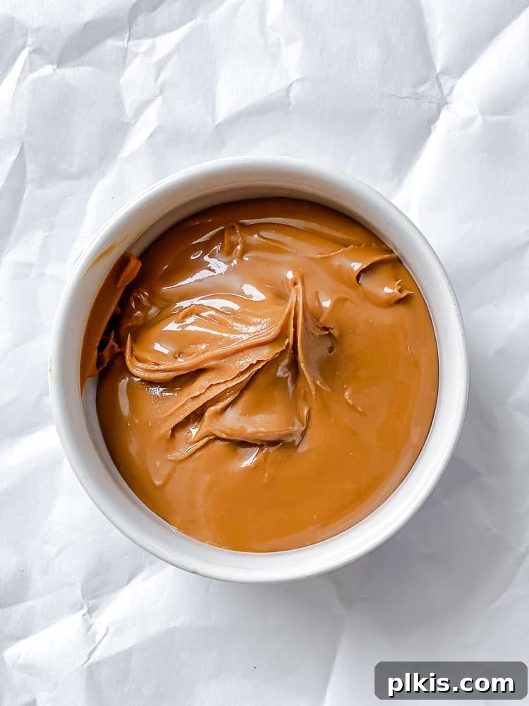 Two-Ingredient Biscoff Fudge Bliss 4 Process shot of melted Biscoff cookie butter in a microwave-safe bowl, ready for the next step of making fudge.