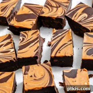completed Easy Biscoff Fudge [2-Ingredient] in squares on a white surface