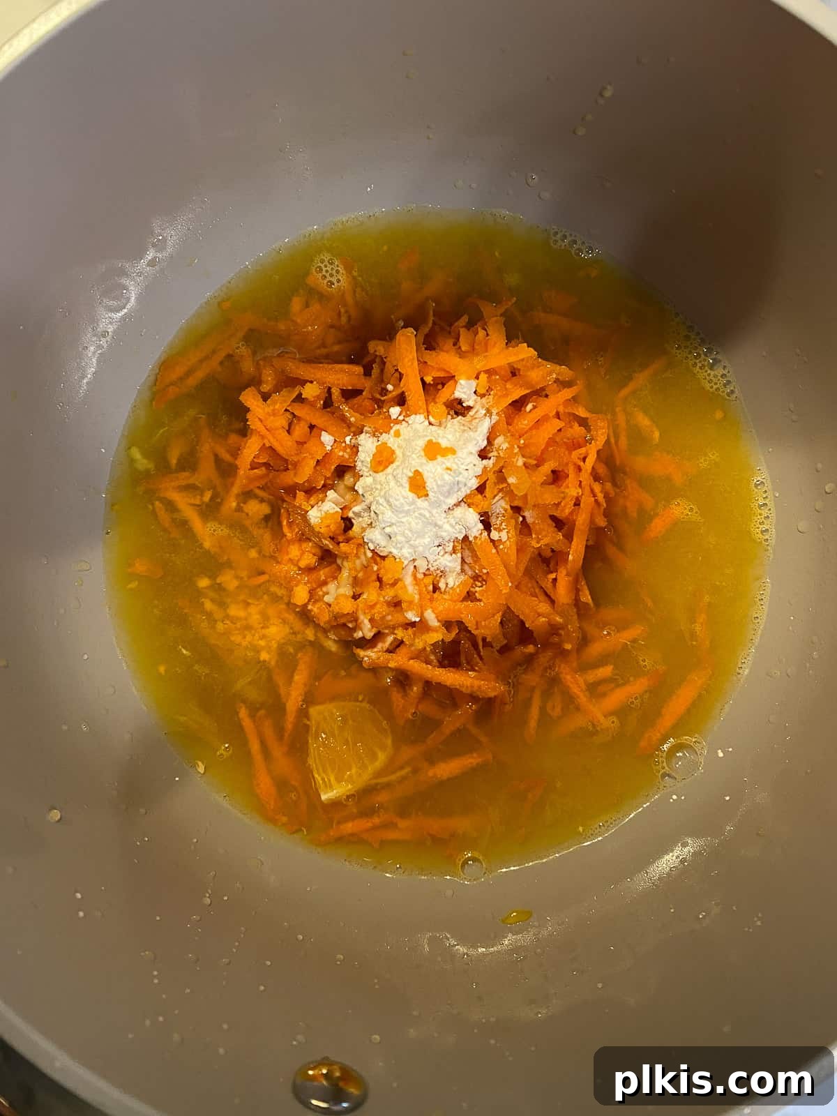 Process shot showing all glaze ingredients combined in a pan, simmering and thickening into a vibrant sauce.