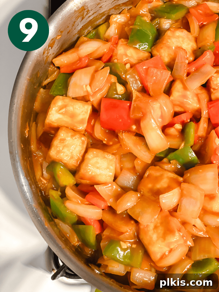 Golden Sweet and Sour Tofu 12 Process shot showing the tofu and vegetables coated in the sauce, simmering gently in the pan.