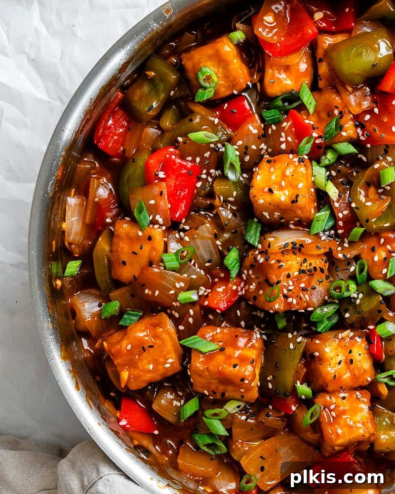 Golden Sweet and Sour Tofu 14 A completed dish of Sweet and Sour Tofu, garnished with green onions and sesame seeds, presented beautifully for serving.