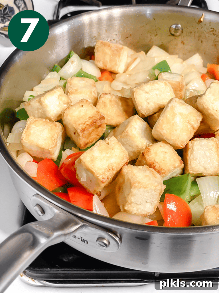 Golden Sweet and Sour Tofu 10 Process shot showing the crispy tofu being added back into the pan with the sautéed vegetables.