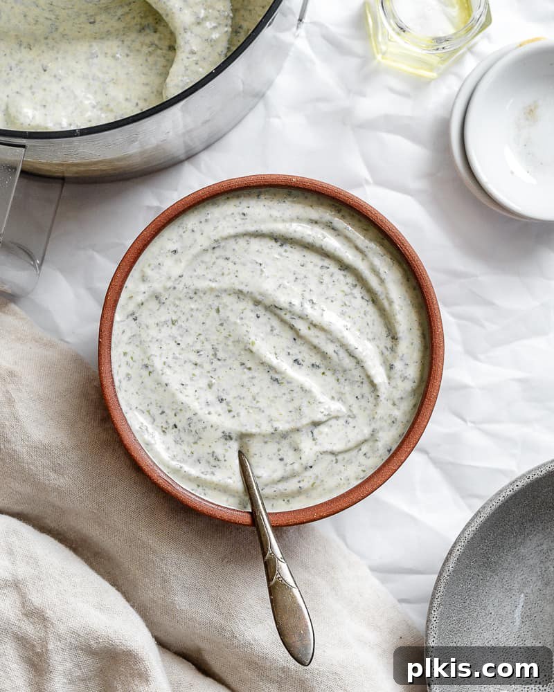 Creamy Vegan Caesar 6 completed Vegan Caesar Dressing in a beautiful white bowl, garnished with herbs