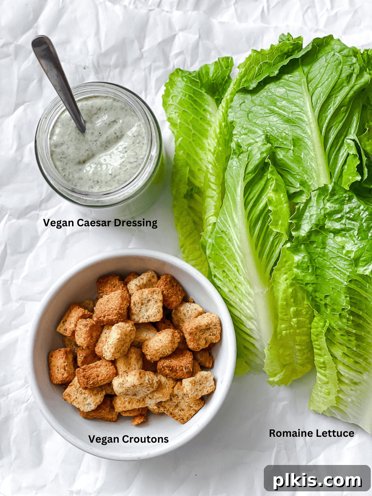 Ultimate Vegan Caesar 3 ingredients for completed Vegan Caesar Salad plated