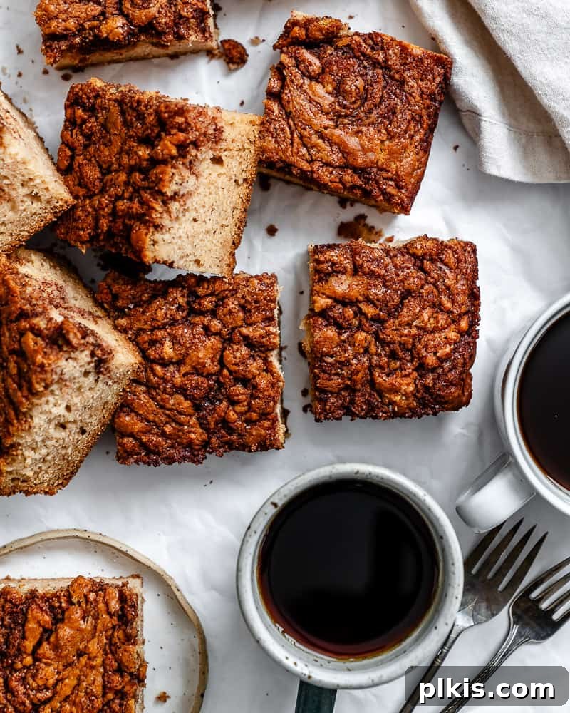 Irresistible Vegan Coffee Cake 12 Sliced vegan coffee cake squares presented neatly on a white background, highlighting the cinnamon swirl.