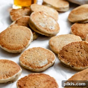 several completed Easy Vegan Pancakes [Regular or Mini] on a white surface