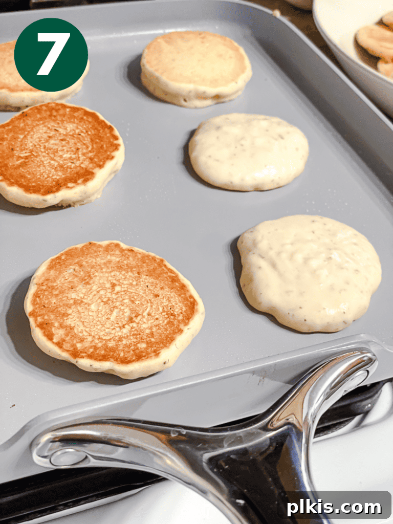 several completed Easy Vegan Pancakes [Regular or Mini] on a white surface