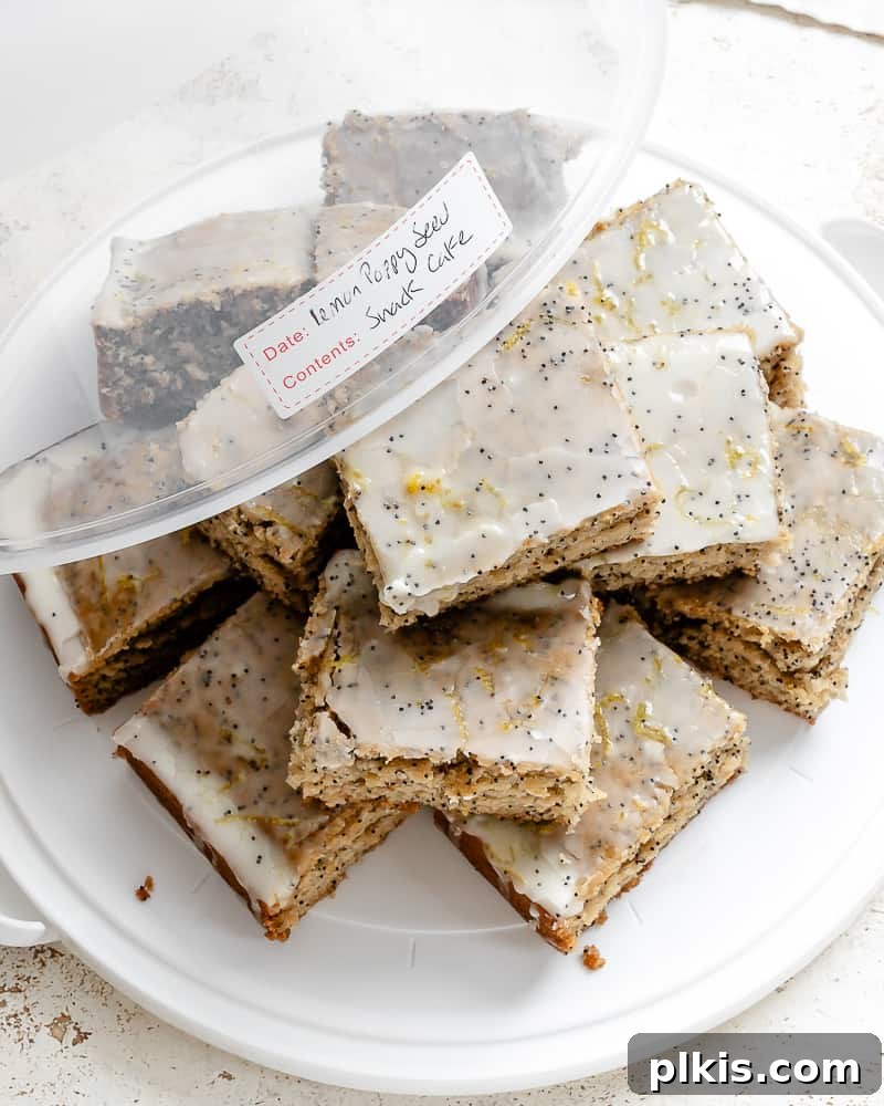 Zesty Lemon Poppy Seed Cake 9 Multiple slices of vegan lemon poppy seed cake stacked elegantly on a white plate, ready to be enjoyed.