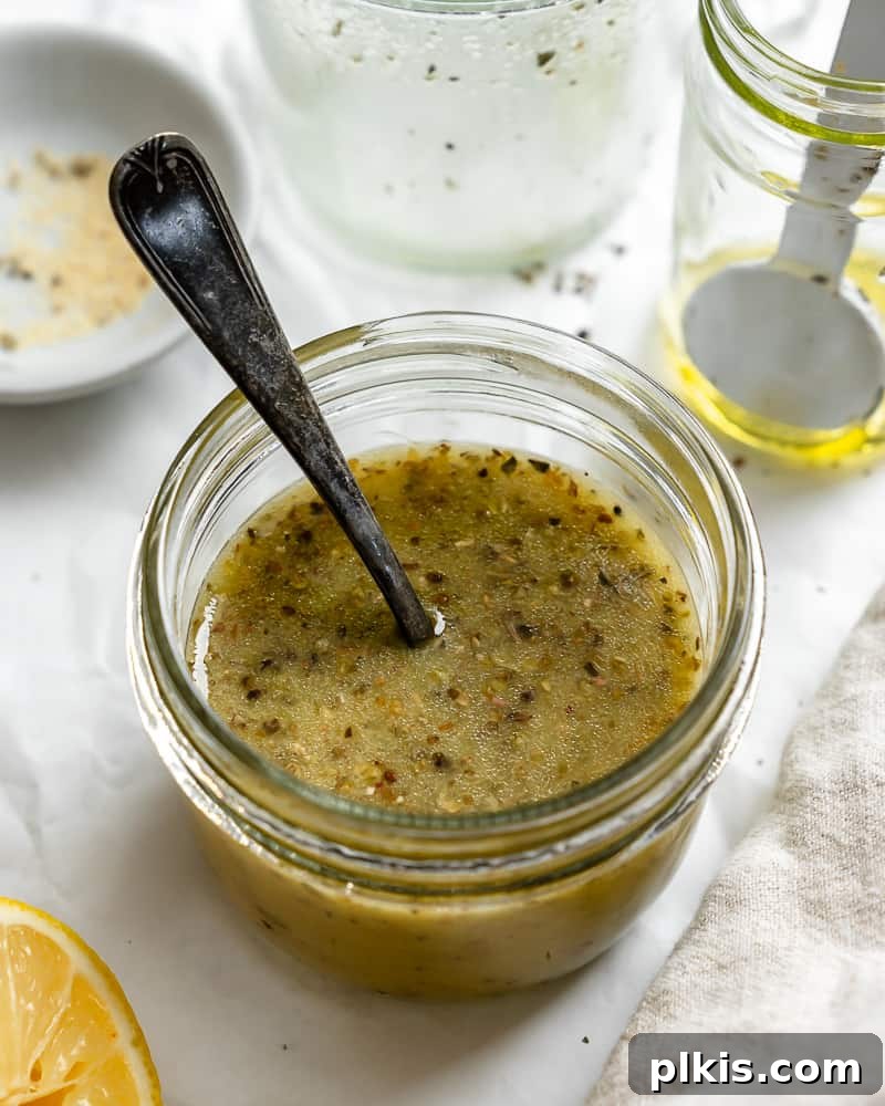 3-Minute Plant-Based Italian Dressing 2 A jar filled with vibrant homemade vegan Italian dressing, showcasing its rich color and herbaceous texture, ready to be enjoyed.