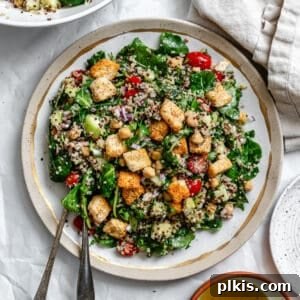 Power-Packed Kale Quinoa Salad 12 completed Kale Quinoa Salad plated on a white surface