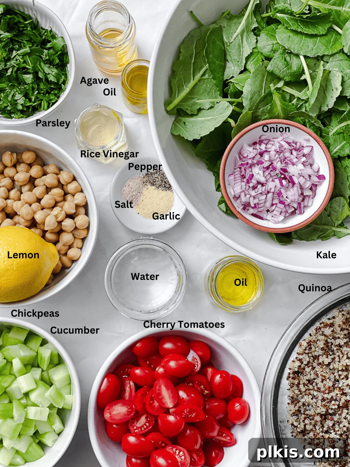 Power-Packed Kale Quinoa Salad 3 All the fresh and vibrant ingredients for the Kale Quinoa Salad meticulously measured and laid out on a clean white surface, ready for preparation.