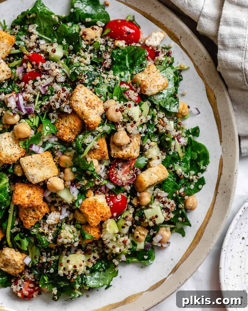 Power-Packed Kale Quinoa Salad 10 A second view of the delectable Kale Quinoa Salad, presented elegantly on a white surface, showcasing its vibrant freshness and appealing texture.