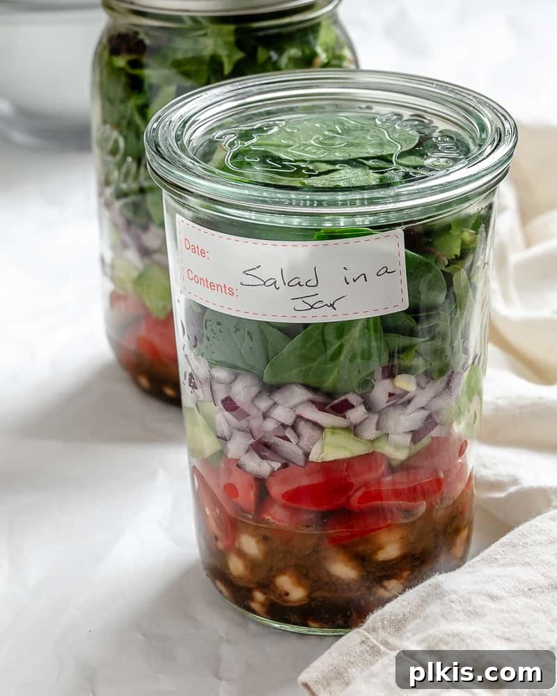 Jarred Quinoa Chickpea Power Salad 12 A close-up of a beautifully assembled Quinoa Chickpea Salad in a mason jar, highlighting its fresh ingredients and perfect layers.