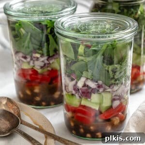 completed Quinoa Chickpea Salad [In A Jar] against a white background