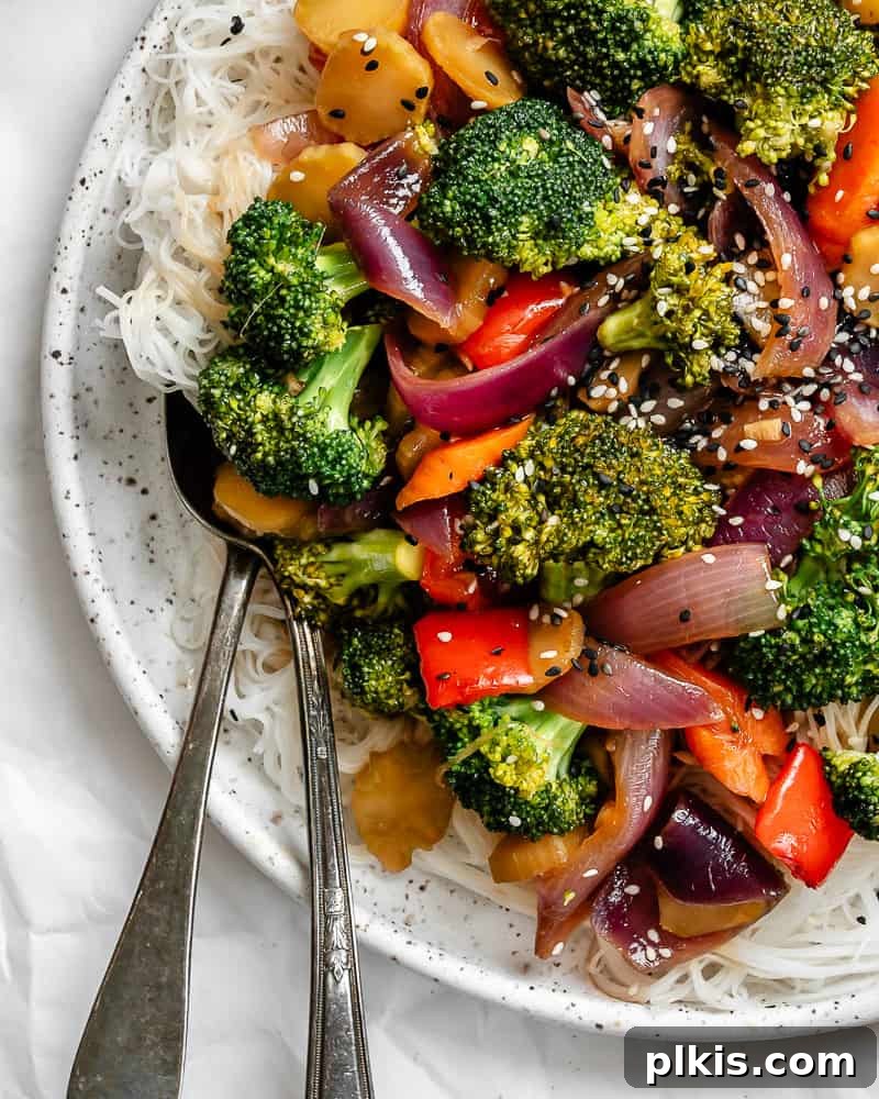 Completed Easy Garlic Broccoli Stir-Fry on a white plate, garnished and ready to be served.