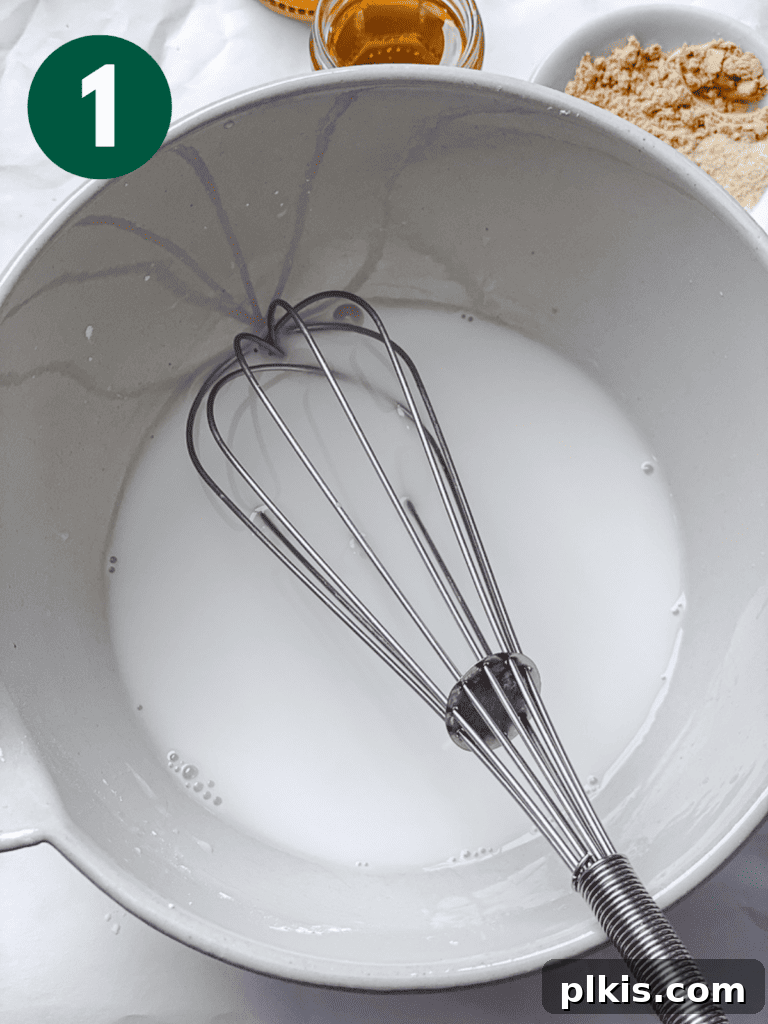 Process shot of whisking cornstarch and water in a small bowl for the stir-fry sauce.
