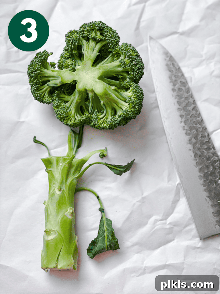 Process shot of preparing broccoli: separating florets and slicing the stem.