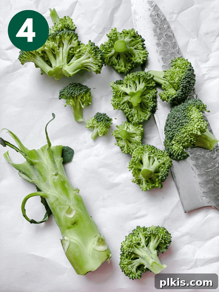 Close-up process shot of slicing broccoli florets and preparing the stem.