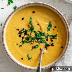 completed Slow Cooker Pumpkin Soup on a white surface