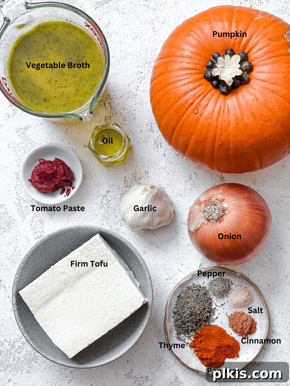 Cozy Slow Cooker Spiced Pumpkin Bisque 3 ingredients for Slow Cooker Pumpkin Soup on a white surface
