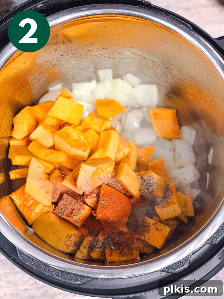 Cozy Slow Cooker Spiced Pumpkin Bisque 5 process shot showing added ingredients in pot