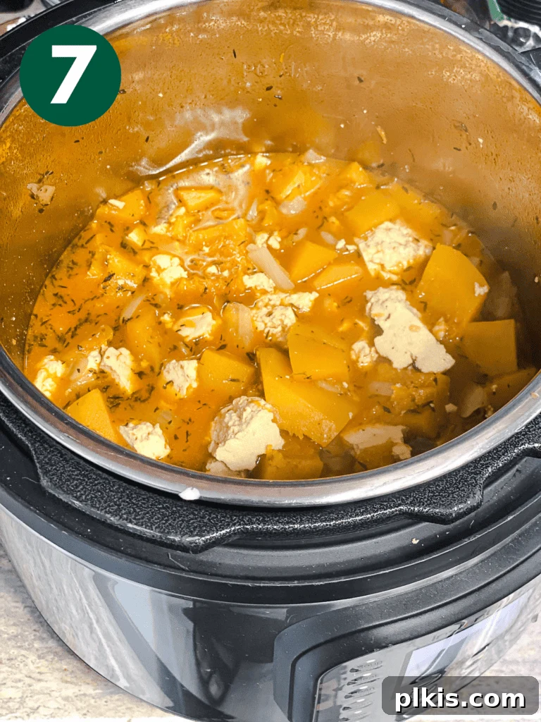 Cozy Slow Cooker Spiced Pumpkin Bisque 10 process shot showing soup cooking in instant pot