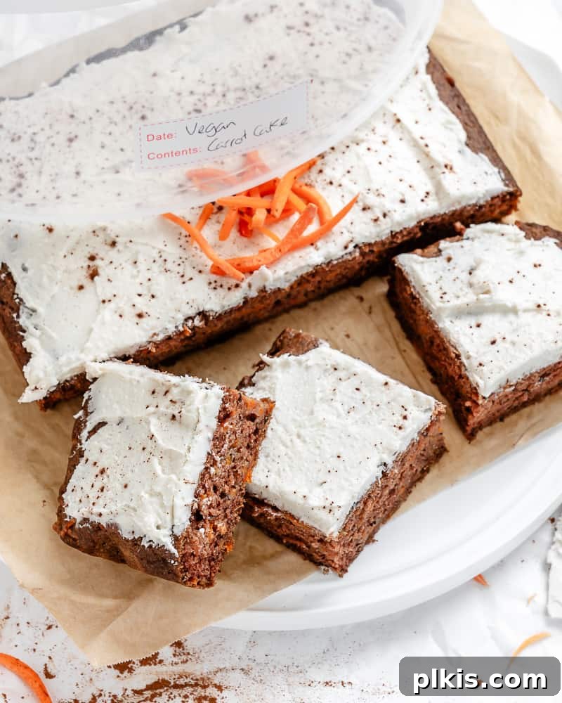 A completed Vegan Carrot Cake on a white surface, presented in a clean, appealing manner, highlighting its perfect bake and frosting.