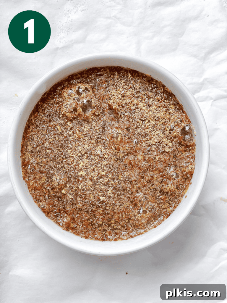 A small bowl containing the flaxseed mixture, thickened and ready for use in the vegan carrot cake batter.
