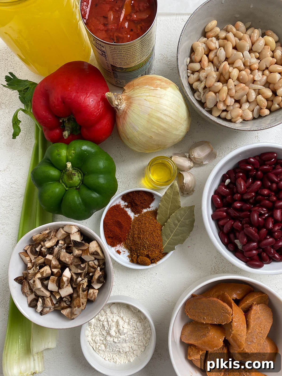 Hearty Plant-Based Gumbo 3 ingredients for vegan gumbo spread out on a white surface, ready for preparation