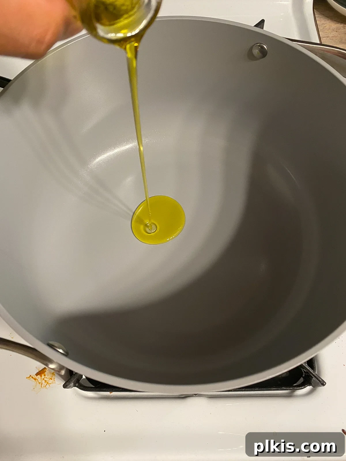 Hearty Plant-Based Gumbo 4 process shot of oil being poured onto a pan, illustrating the first step