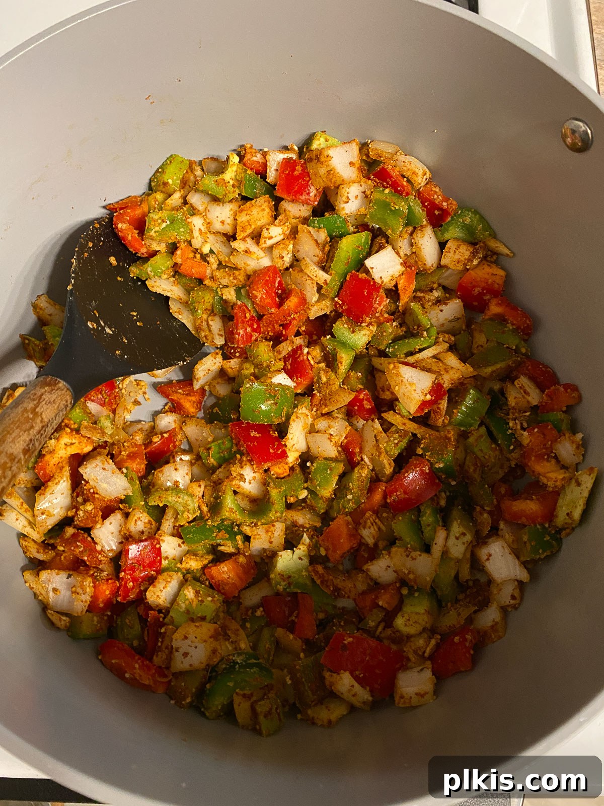 Hearty Plant-Based Gumbo 8 process shot of vegetables, spices, and flour being mixed thoroughly in the pan