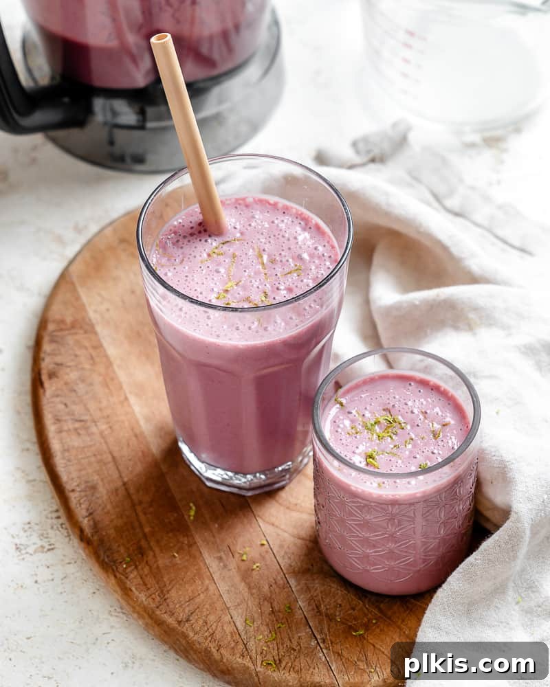Effortless Raspberry Refresh 2 A vibrant, creamy banana raspberry smoothie in glasses, garnished with fresh raspberries and mint, ready to be enjoyed as a healthy breakfast or snack.