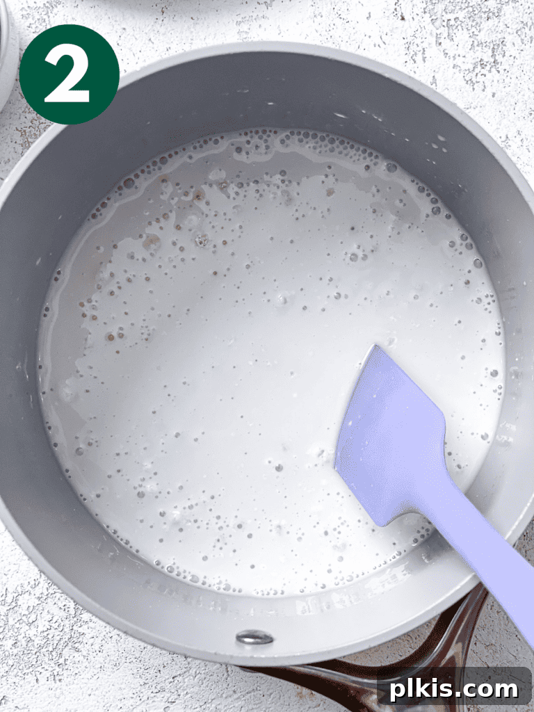 Velvety Vegan Coconut Dream Pie 5 A process image demonstrating the mixing of cornstarch and sugar with coconut milk in a saucepan, ensuring a smooth base for the vegan coconut cream pie filling.