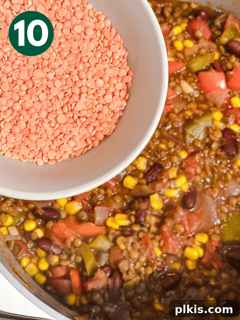 Hearty Lentil and Bean Chili 13 Red lentils being gently folded into the hot chili mixture, which will soften and thicken the dish off the heat.