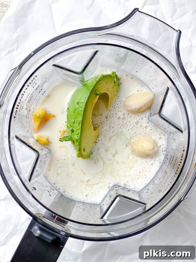 Tropical Mango Avocado Dream 4 First step: Adding liquid ingredients and avocado into a blender jar.