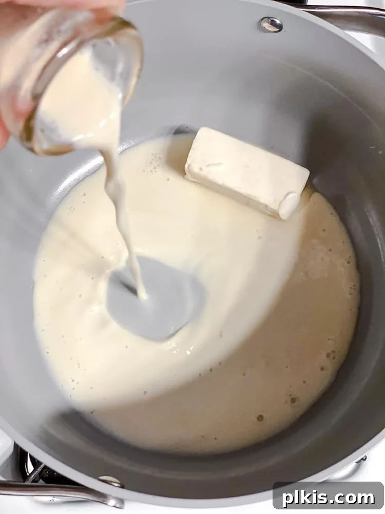 Elevate Your Boxed Mac and Cheese 7 process shot of adding plant-based milk to pot