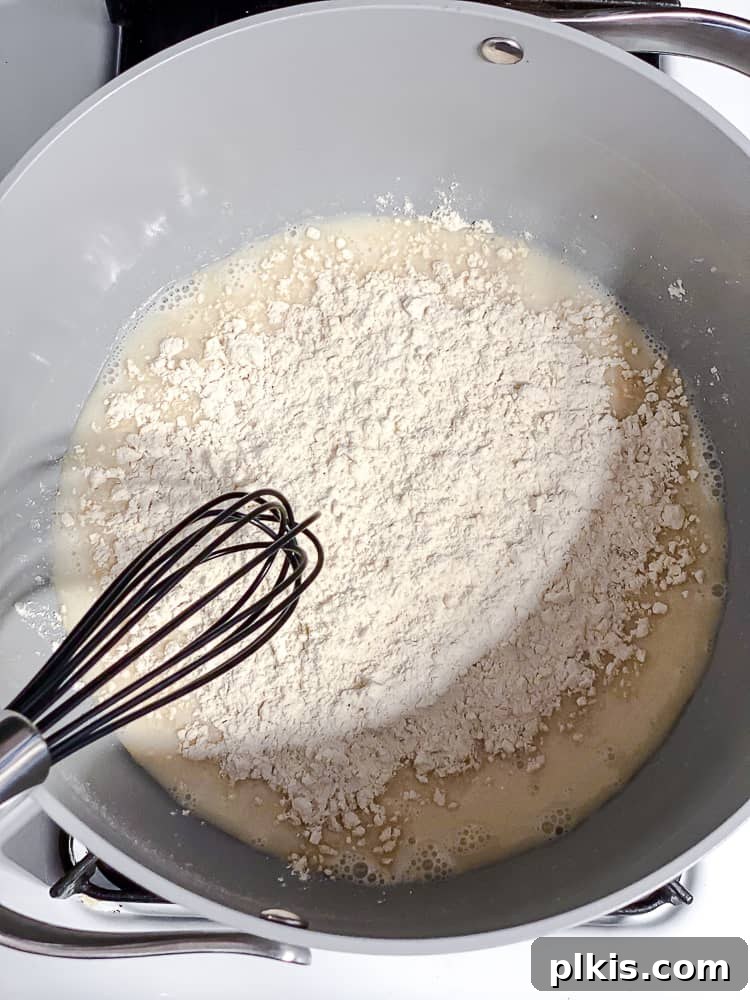 Elevate Your Boxed Mac and Cheese 9 process shot of stirring ingredients in pot