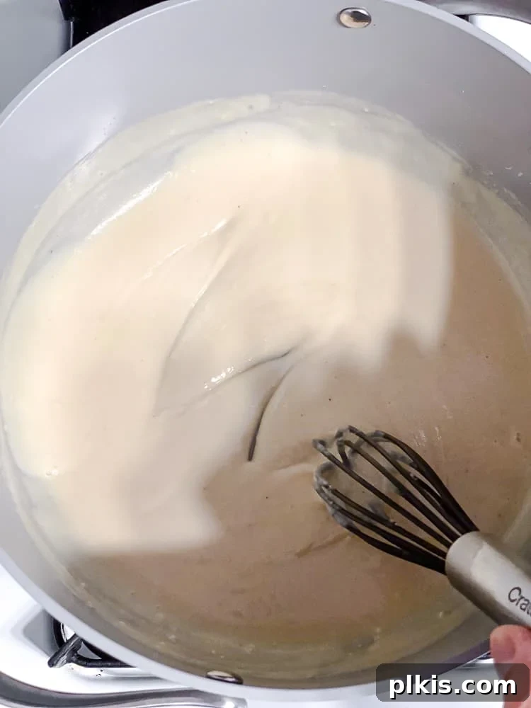 Elevate Your Boxed Mac and Cheese 10 process shot of stirring ingredients in pot